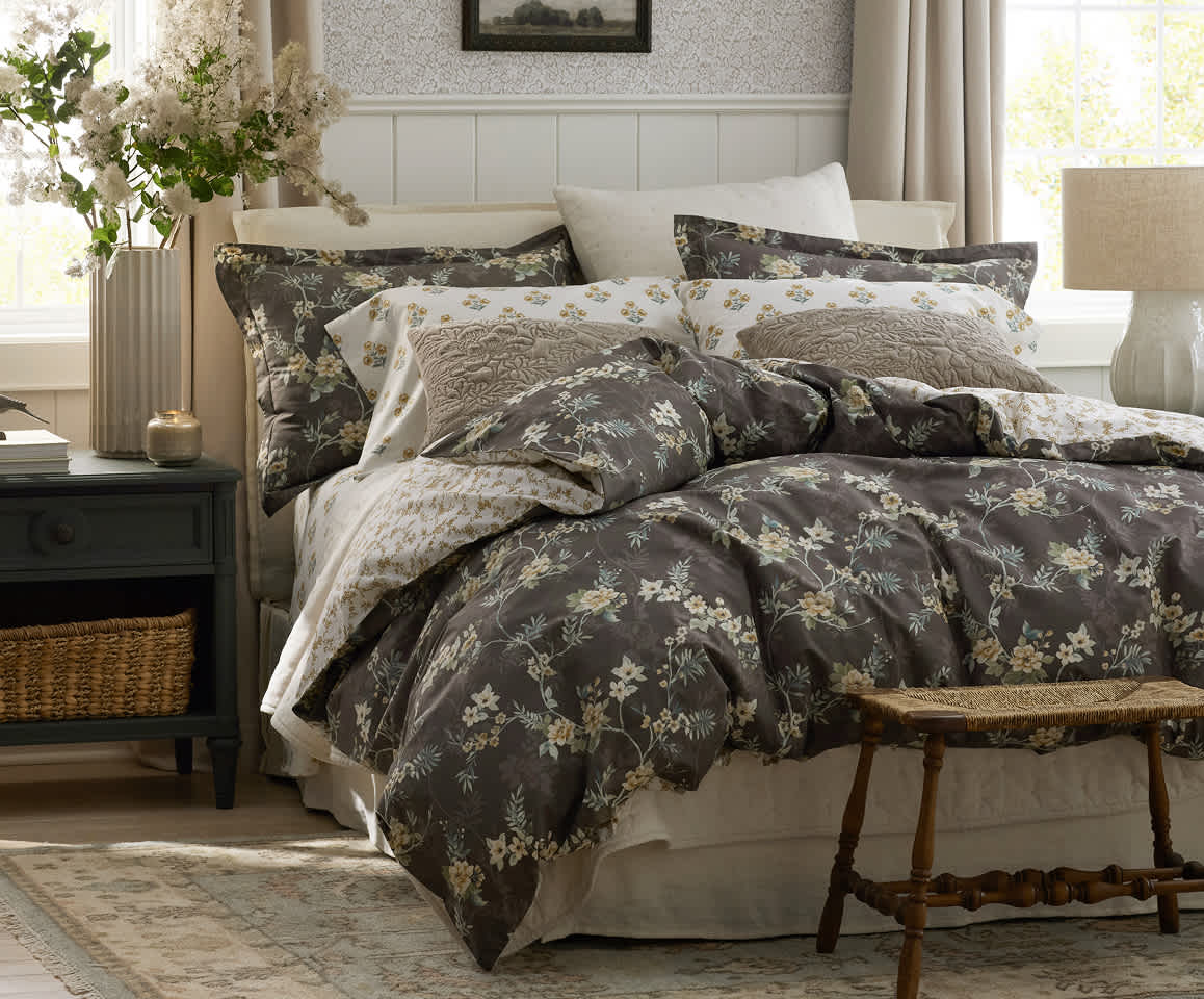 Stoffer Home x The Company Store bedding on a bed in a sunlit bedroom