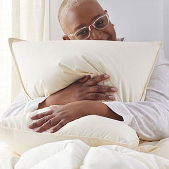 Woman hugging organic pillow