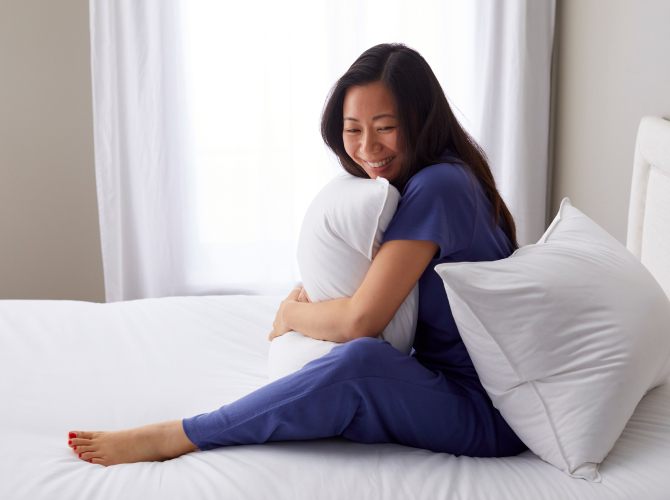 woman holding pillows