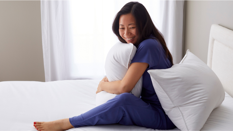 woman holding pillows